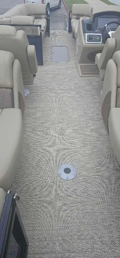 Slide: The Image of 2024 Regency 250 LE3 pontoon boat interior with beige seating and carpet. - 4