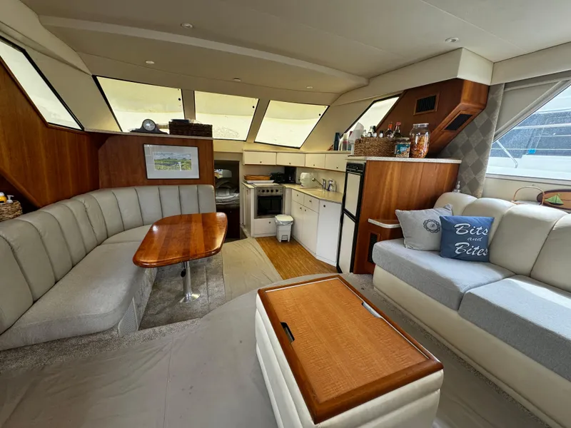 Slide: The Image of Interior of a 1999 Silverton 392 Motor Yacht with kitchen and seating area. - 13