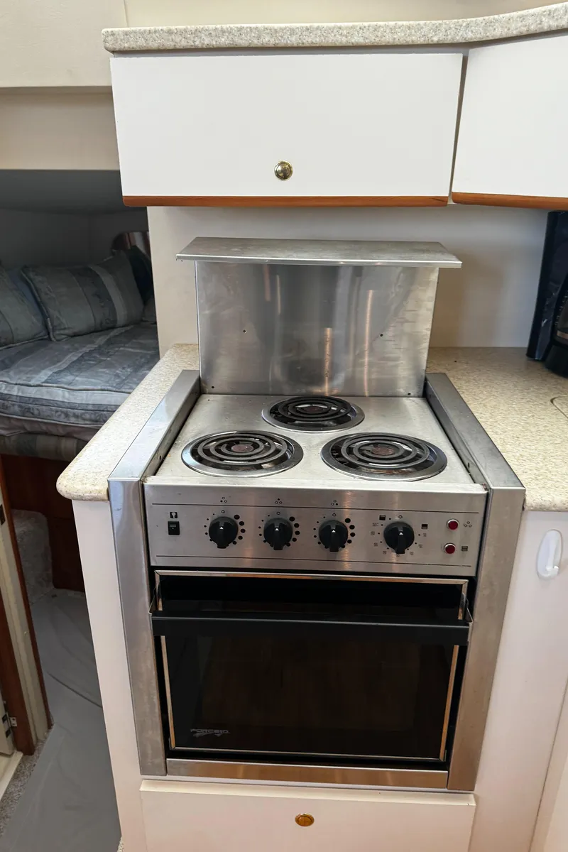 Slide: The Image of 1999 Silverton 392 Motor Yacht kitchen with electric stove and oven. - 16