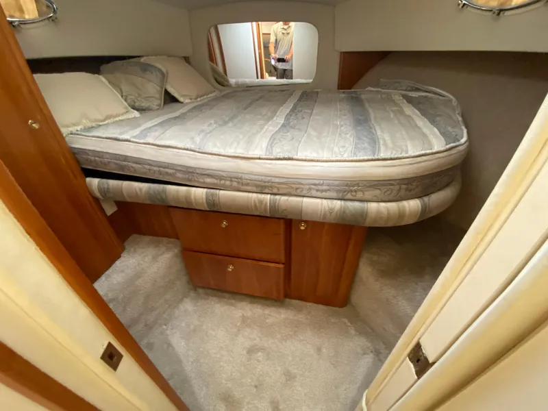 Slide: The Image of 1999 Silverton 392 Motor Yacht bedroom with double bed and storage drawers. - 17