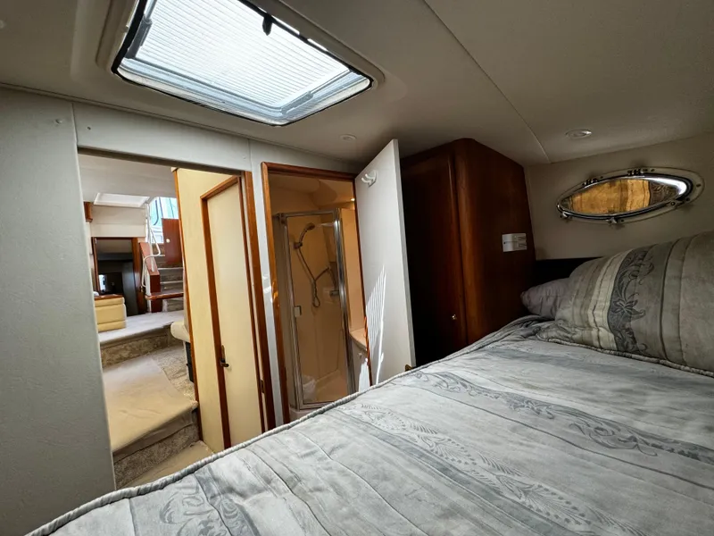 Slide: The Image of Interior of 1999 Silverton 392 Motor Yacht bedroom with skylight and bathroom. - 18
