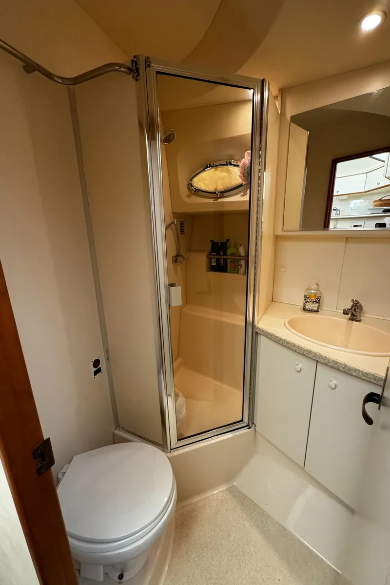 Slide: The Image of 1999 Silverton 392 Motor Yacht bathroom with shower, sink, and toilet. - 19