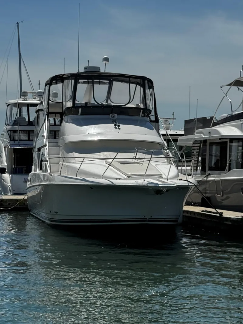 Slide: The Image of 1999 Silverton 392 Motor Yacht docked at a marina. - 2