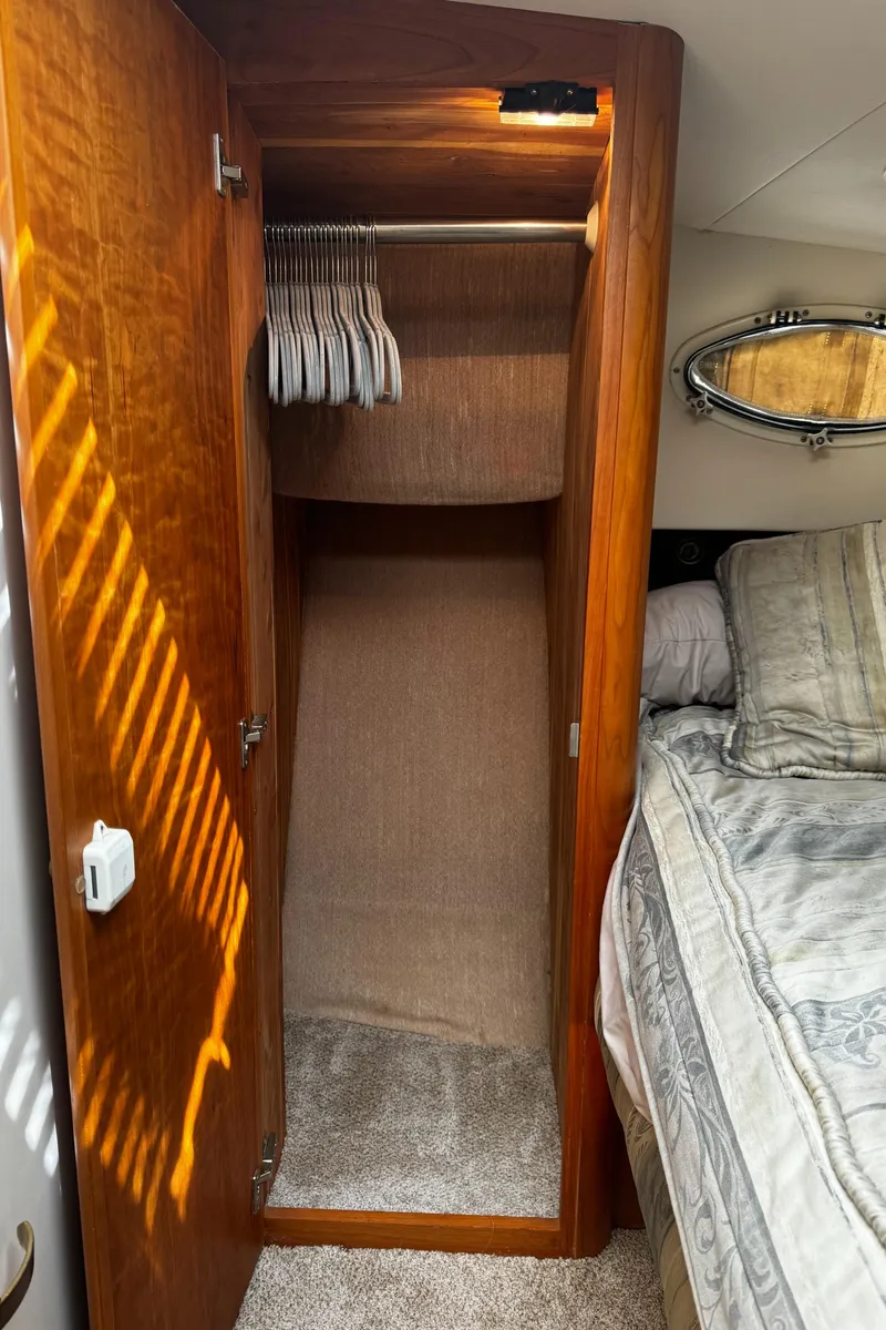Slide: The Image of Wooden closet in 1999 Silverton 392 Motor Yacht bedroom with hangers and bed. - 20