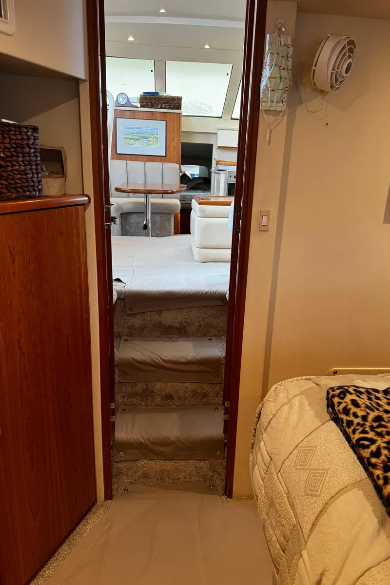 Slide: The Image of Interior of 1999 Silverton 392 Motor Yacht with cozy living area and steps. - 26