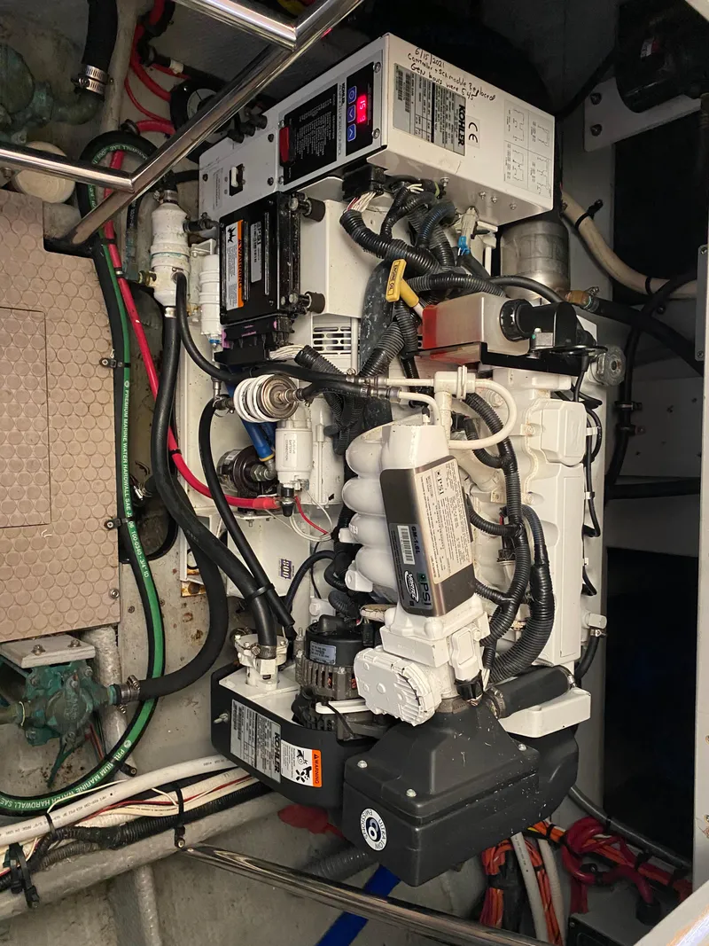 Slide: The Image of Engine compartment of a 1999 Silverton 392 Motor Yacht with various mechanical components. - 35