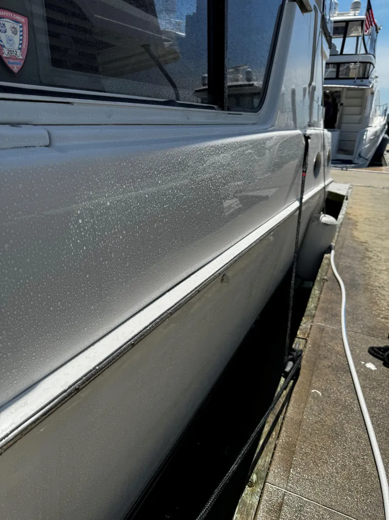 Slide: The Image of Side view of a 1999 Silverton 392 Motor Yacht docked at a marina. - 6