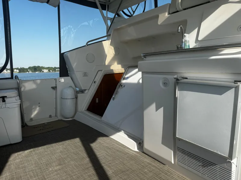 Slide: The Image of Interior of 1999 Silverton 392 Motor Yacht with kitchenette and lake view. - 8