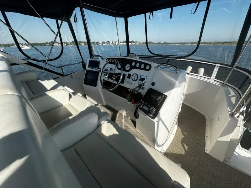 Slide: The Image of 1999 Silverton 392 Motor Yacht helm with panoramic water view. - 9