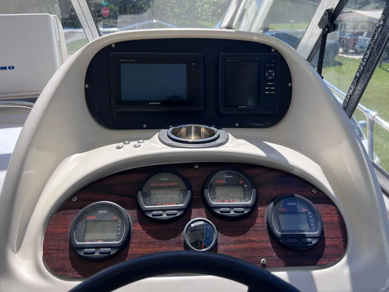 Slide: The Image of 1998 Grady-White F-26 Tigercat dashboard with gauges and navigation screens. - 13