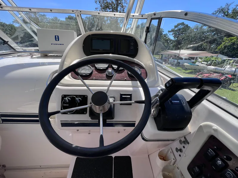 Slide: The Image of 1998 Grady-White F-26 Tigercat boat helm with steering wheel and controls. - 14