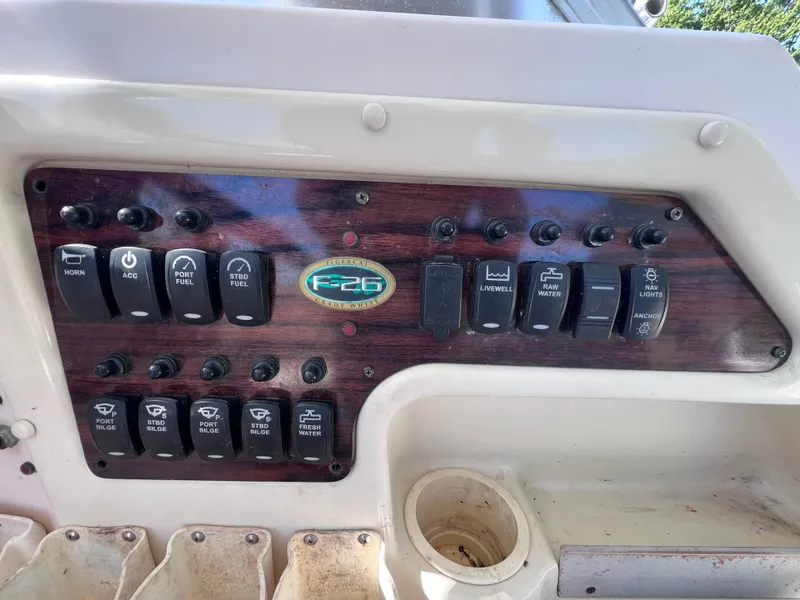Slide: The Image of Control panel of a 1998 Grady-White F-26 Tigercat boat with various switches. - 15
