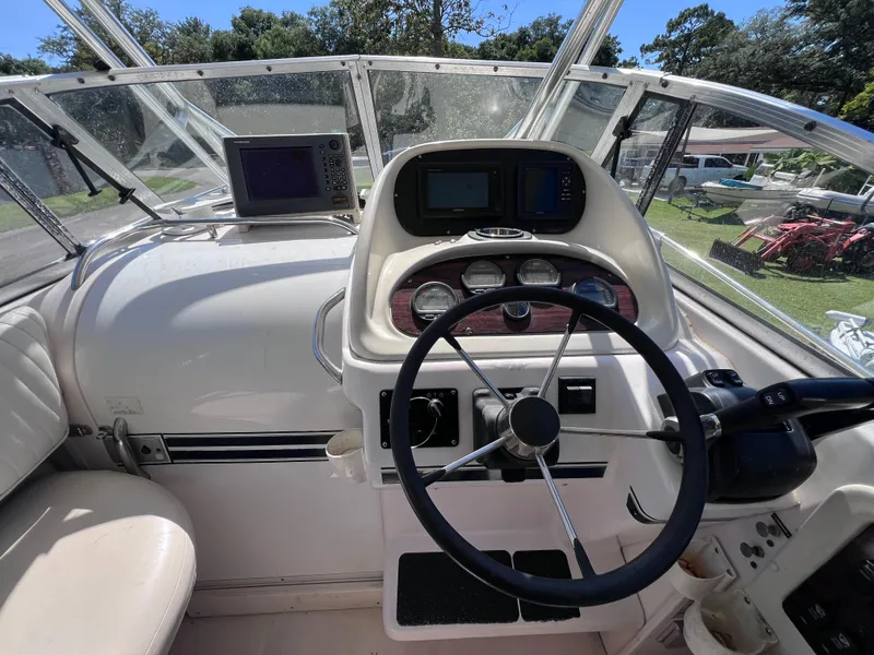 Slide: The Image of 1998 Grady-White F-26 Tigercat boat helm with steering wheel and navigation equipment. - 16