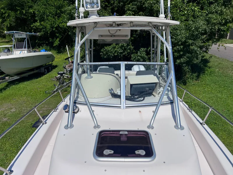 Slide: The Image of 1998 Grady-White F-26 Tigercat boat with hardtop and windshield, docked on grass. - 21