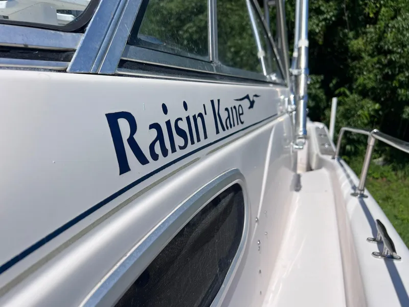 Slide: The Image of 1998 Grady-White F-26 Tigercat boat named Raisin' Kane side view. - 26