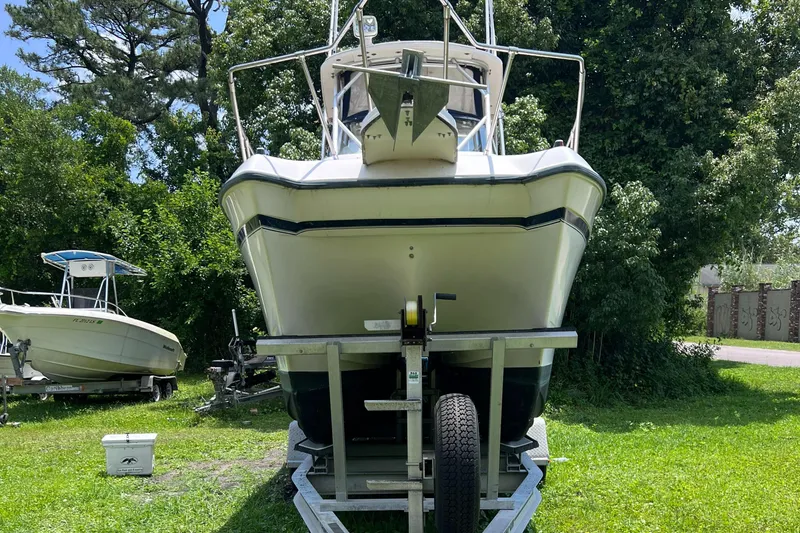 Slide: The Image of 1998 Grady-White F-26 Tigercat boat on a trailer in a grassy area. - 34