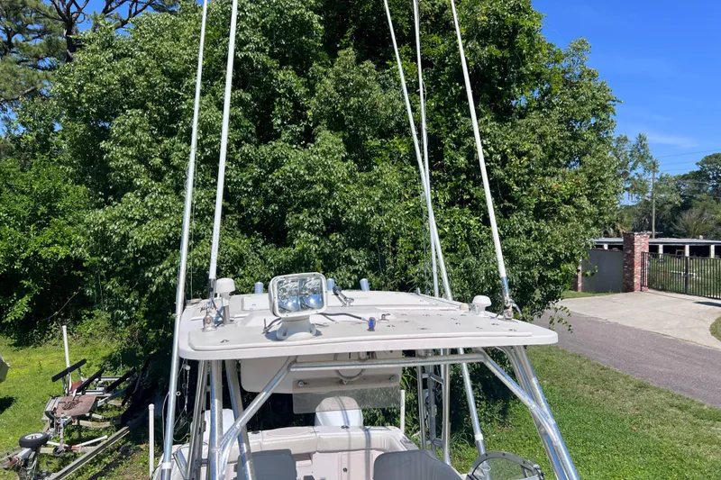 Slide: The Image of 1998 Grady-White F-26 Tigercat boat with fishing equipment, parked on a grassy area. - 41