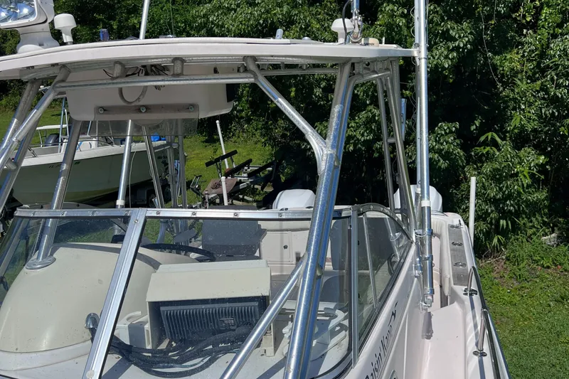 Slide: The Image of 1998 Grady-White F-26 Tigercat boat with a hardtop and windshield, docked outdoors. - 43