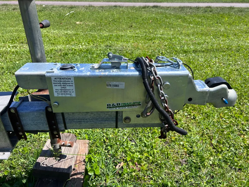Slide: The Image of Close-up of a 1998 Grady-White F-26 Tigercat trailer hitch on grass. - 5