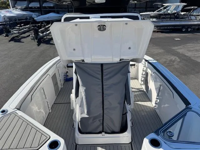 Slide: The Image of 2024 Yamaha Boats 255 FSH Sport H interior with open storage compartment. - 10