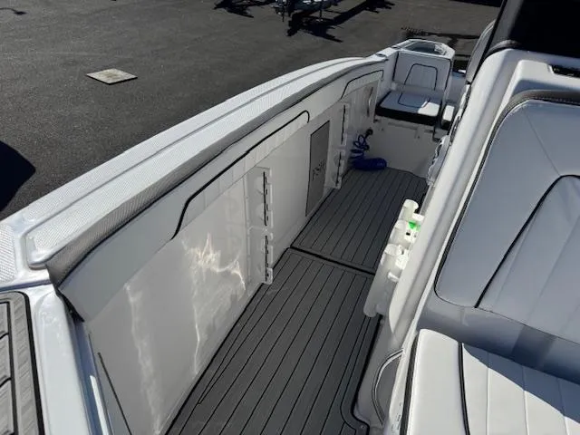 Slide: The Image of 2024 Yamaha Boats 255 FSH Sport H interior with sleek seating and storage compartments. - 11