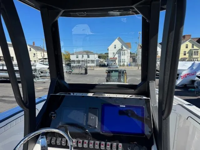 Slide: The Image of 2024 Yamaha Boats 255 FSH Sport H dashboard with navigation controls and steering wheel. - 13