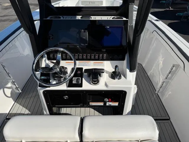 Slide: The Image of 2024 Yamaha Boats 255 FSH Sport H dashboard with steering wheel and controls. - 14