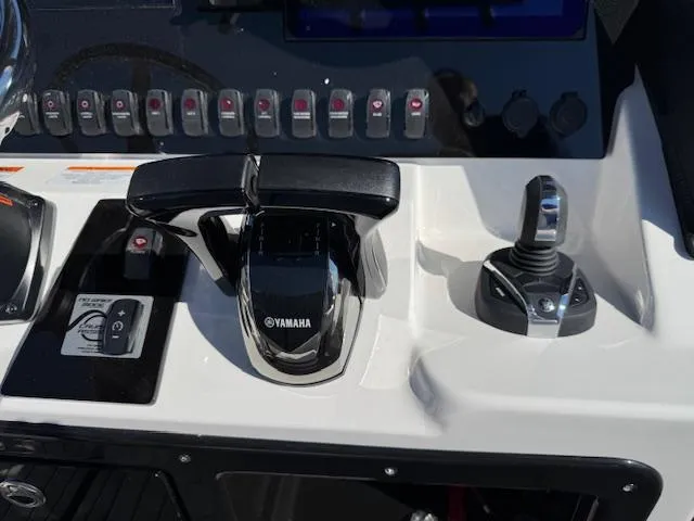 Slide: The Image of 2024 Yamaha Boats 255 FSH Sport H control panel with throttle and joystick. - 16