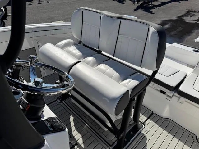 Slide: The Image of 2024 Yamaha Boats 255 FSH Sport H interior seating and steering wheel detail. - 17