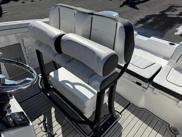 Slide: The Image of 2024 Yamaha Boats 255 FSH Sport H interior seating with steering wheel. - 18