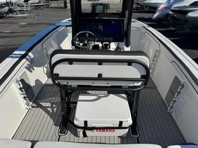 Slide: The Image of 2024 Yamaha Boats 255 FSH Sport H interior with steering console and seating. - 20
