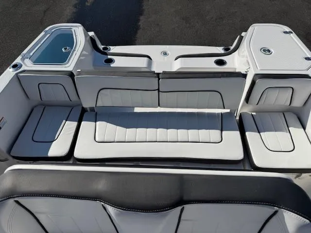 Slide: The Image of 2024 Yamaha Boats 255 FSH Sport H interior seating, white upholstery, sleek design. - 24