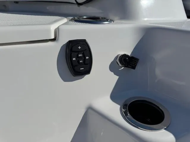 Slide: The Image of 2024 Yamaha Boats 255 FSH Sport H control panel and cup holder detail. - 27