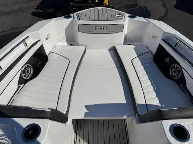 Slide: The Image of 2024 Yamaha Boats 255 FSH Sport H interior with white seating and sleek design. - 5
