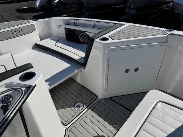 Slide: The Image of 2024 Yamaha Boats 255 FSH Sport H interior with seating and storage compartments. - 7