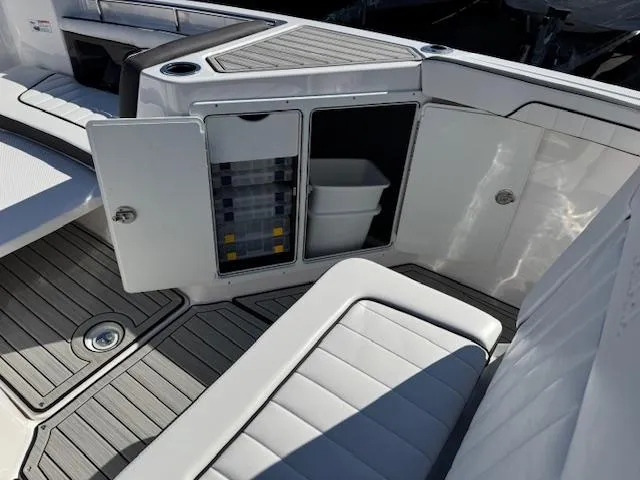 Slide: The Image of 2024 Yamaha Boats 255 FSH Sport H interior storage compartments and seating area. - 8