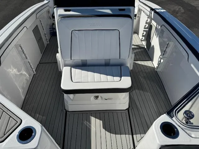 Slide: The Image of 2024 Yamaha Boats 255 FSH Sport H interior with white seating and sleek design. - 9