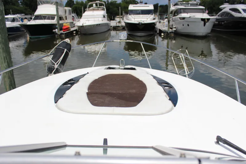 Slide: The Image of 2013 Rinker 31 yacht docked at a marina with other boats. - 12