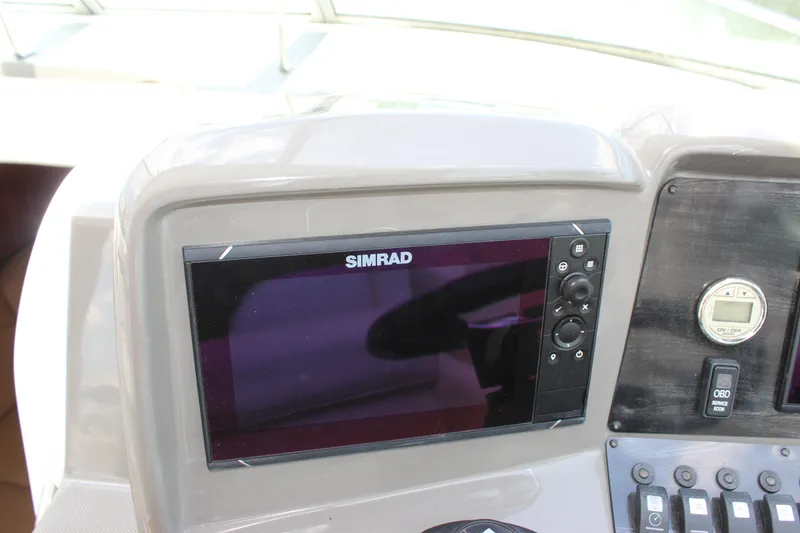 Slide: The Image of Simrad navigation system on 2013 Rinker 31 boat dashboard. - 17