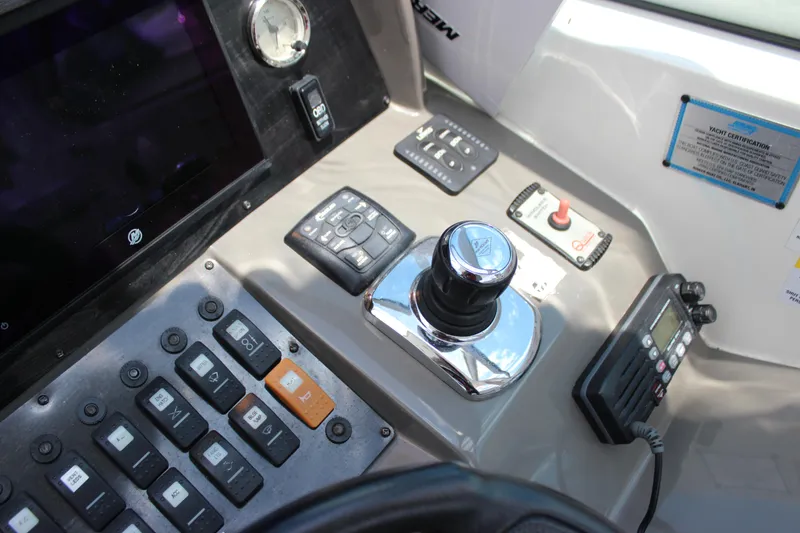 Slide: The Image of Control panel of a 2013 Rinker 31 boat with joystick and electronic controls. - 19