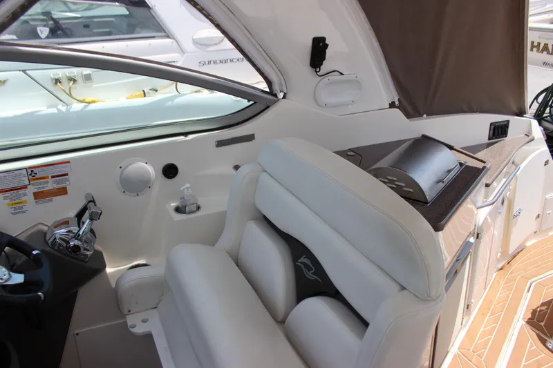 Slide: The Image of 2013 Rinker 31 boat interior with helm, seating, and control panel. - 22