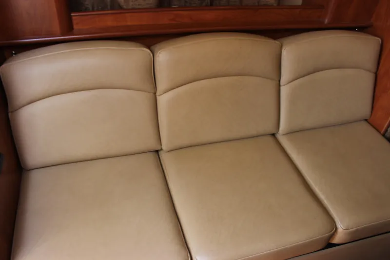 Slide: The Image of Beige leather seating in 2013 Rinker 31 boat interior. - 26