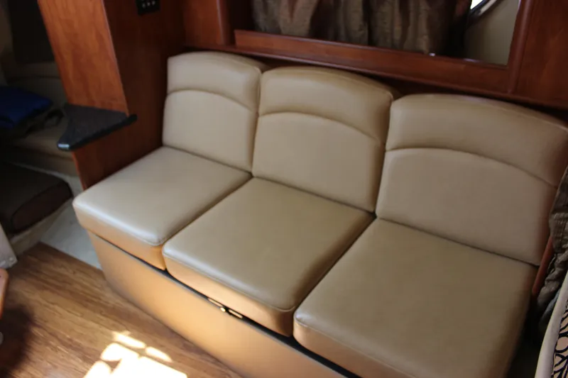 Slide: The Image of 2013 Rinker 31 boat interior with beige leather seating. - 29