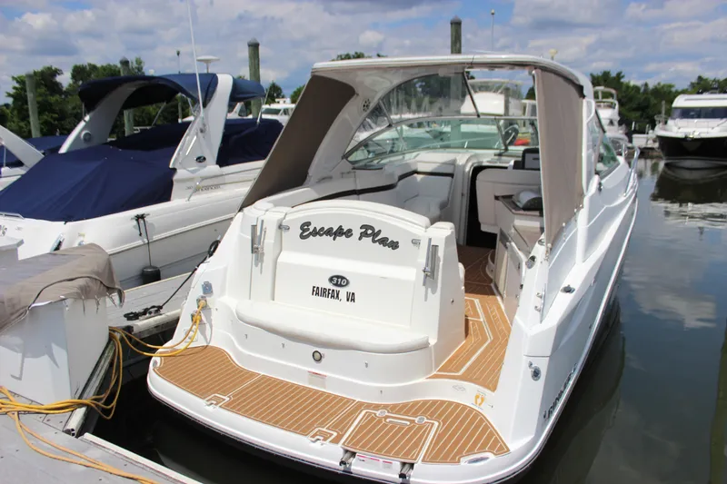 Slide: The Image of 2013 Rinker 31 boat docked at marina, rear view. - 3