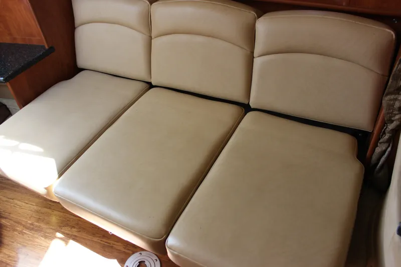 Slide: The Image of Beige leather seating in 2013 Rinker 31 boat interior. - 30