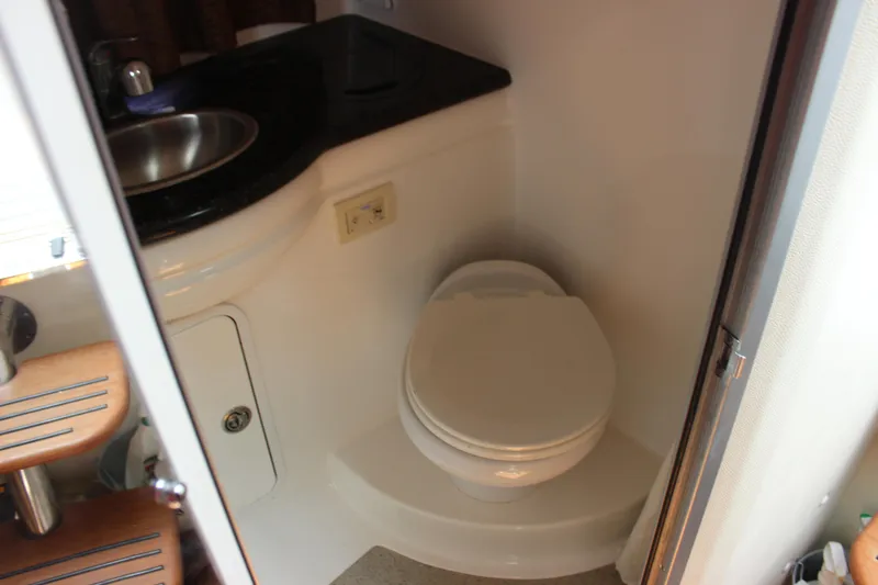 Slide: The Image of Compact bathroom in 2013 Rinker 31 boat with toilet and sink. - 32