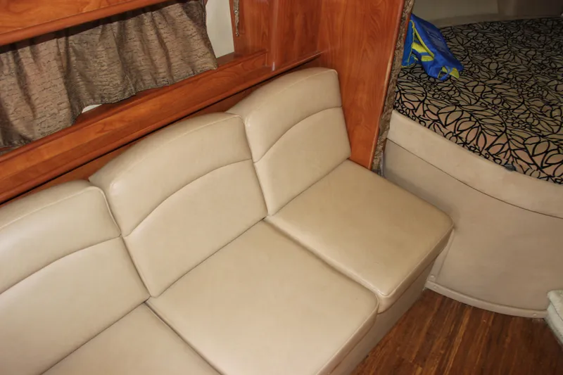 Slide: The Image of Interior of 2013 Rinker 31 boat with beige leather seating and wooden accents. - 38