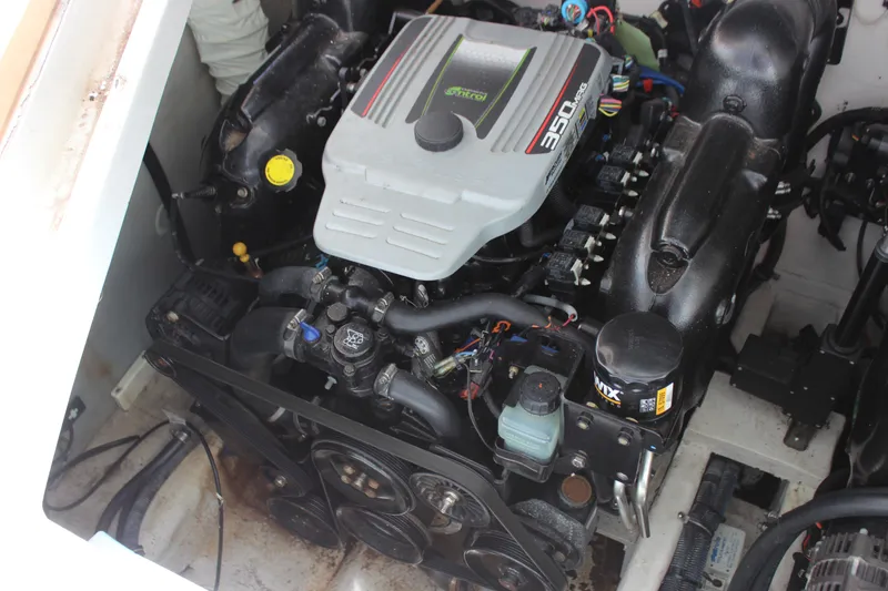 Slide: The Image of 2013 Rinker 31 boat engine compartment with 350 MAG engine. - 40