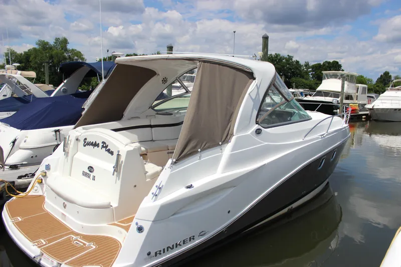 Slide: The Image of 2013 Rinker 31 boat docked in a marina on a sunny day. - 7
