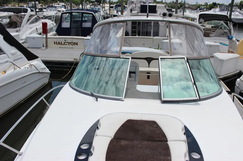 Slide: The Image of 2013 Rinker 31 boat docked at a marina, front view. - 8